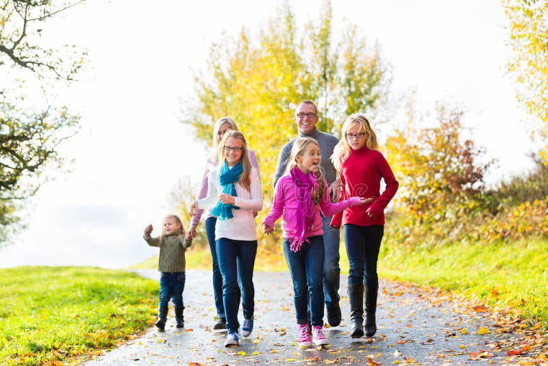 Family taking walk in autumn forest