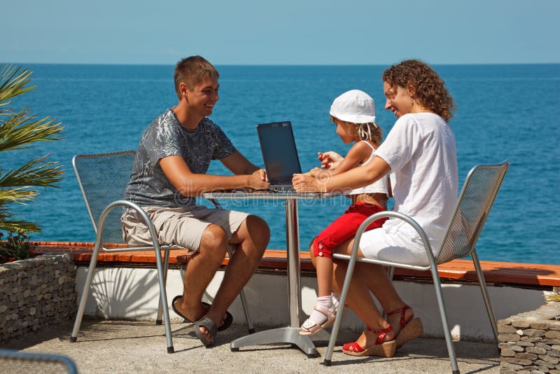 Family of three people resting on sea royalty free stock image