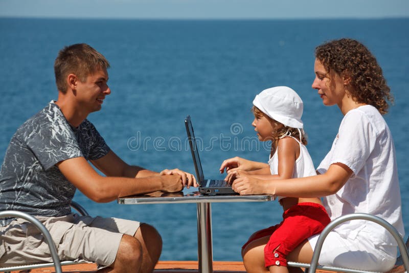 Family of three people resting on sea royalty free stock photos