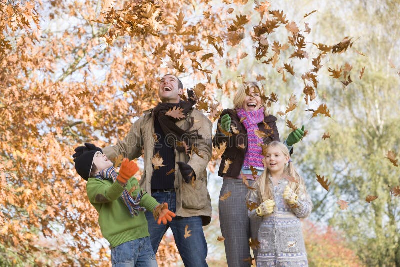 Father throwing autumn leaves in the air. Father throwing autumn leaves in the air