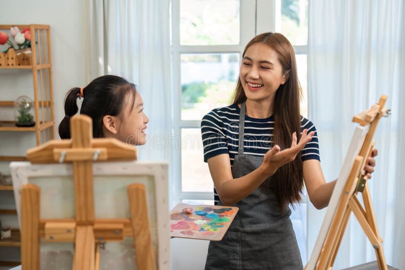 Family time in art: Mother and daughter enjoying painting interactions royalty free stock images