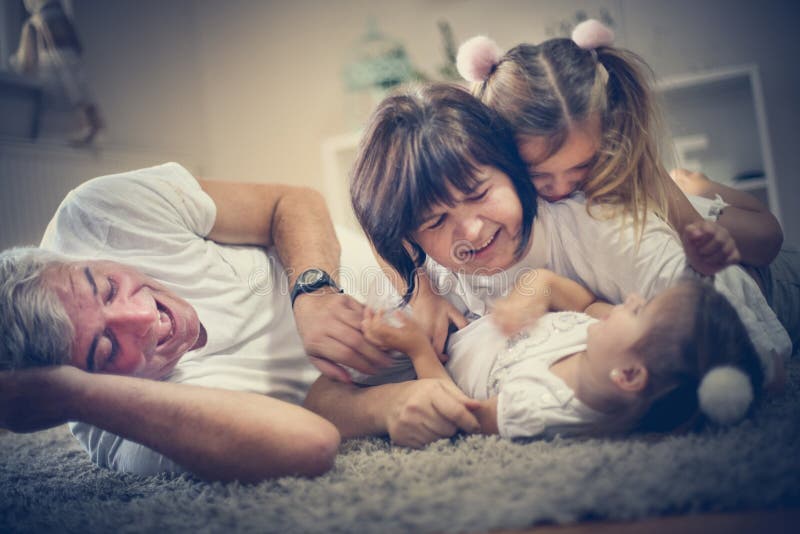 Family time. Grandparents have play with granddaughters. stock photos Family time. Grandparents have play with granddaughters. stock photos