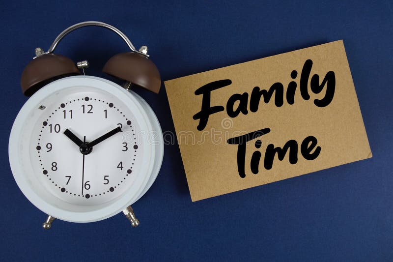Family time text with alarm clock on blue background royalty free stock photo