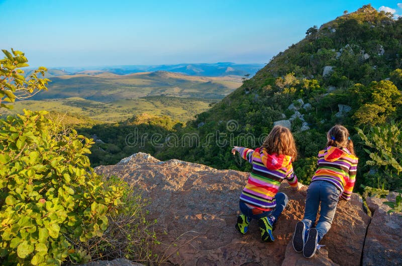 Family travel with children, kids looking from mountain viewpoint, holiday vacation in South Africa