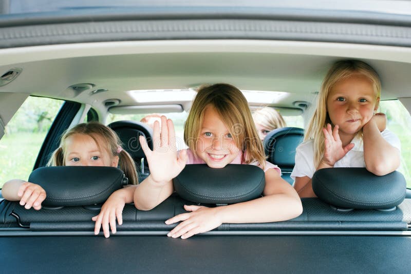 Family with three kids travelling in a car. Family with three kids travelling in a car