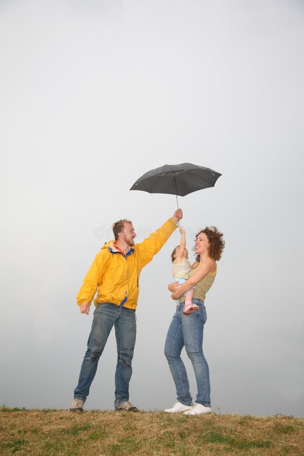 Family under umbrella stock photo. Image of hands, head 2688638