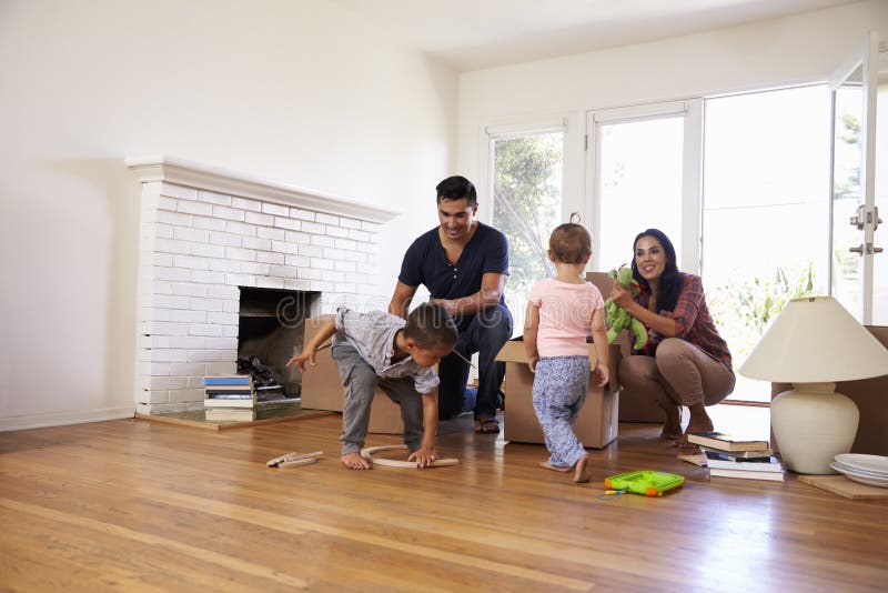 Family Unpacking Boxes In New Home On Moving Day royalty free stock photo Family Unpacking Boxes In New Home On Moving Day royalty free stock photo