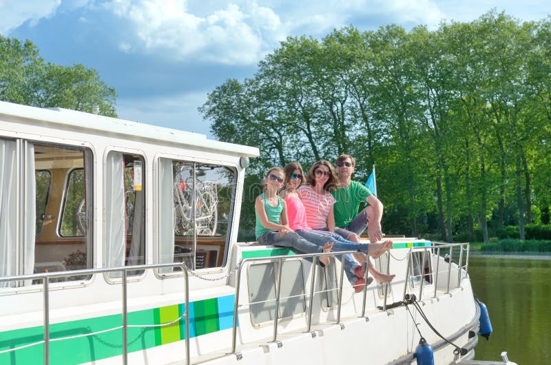 Family vacation, summer holiday travel on barge boat in canal, happy kids and parents having fun on river cruise trip in houseboat