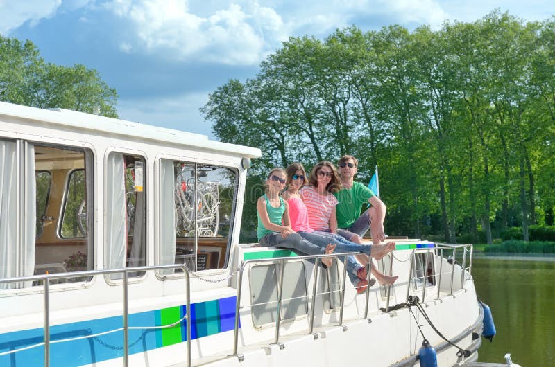 Family vacation, summer holiday travel on barge boat in canal, happy kids and parents having fun on river cruise trip in houseboat