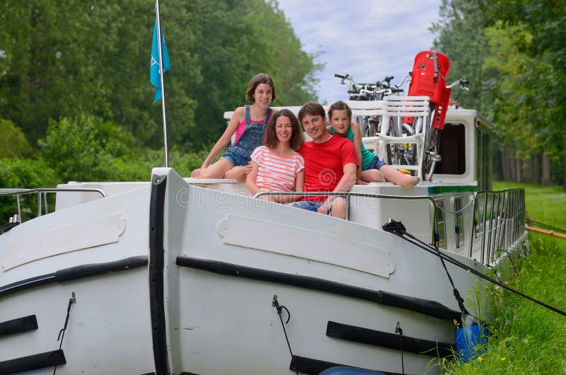 Family vacation, travel on barge boat in canal, parents with kids having fun on river cruise