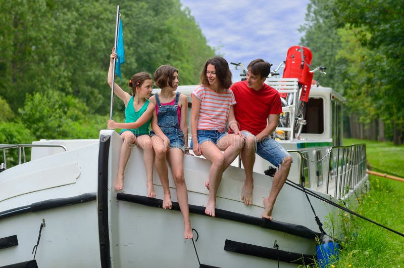 Family vacation, travel on barge boat in canal, parents with kids on river cruise in houseboat