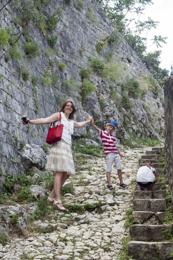 family value. happy mother with her son and daughter climbs the mountain up the steps to see the stunning view from the top of the royalty free stock photos family value. happy mother with her son and daughter climbs the mountain up the steps to see the stunning view from the top of the royalty free stock photos