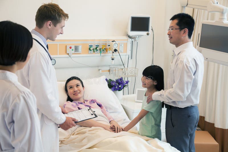 Family visiting the mother in the hospital, discussing with the doctor stock images Family visiting the mother in the hospital, discussing with the doctor stock images