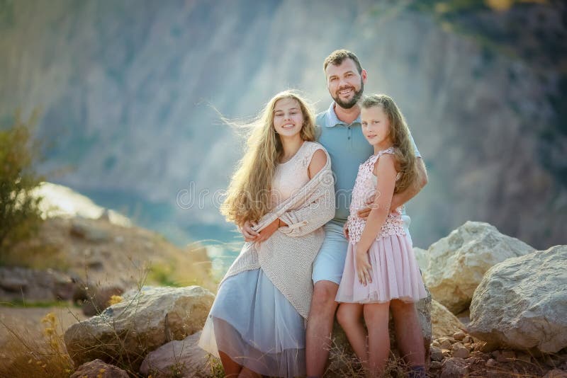 Family During A Walk On The Background Of A Large Mountain Stock Photo