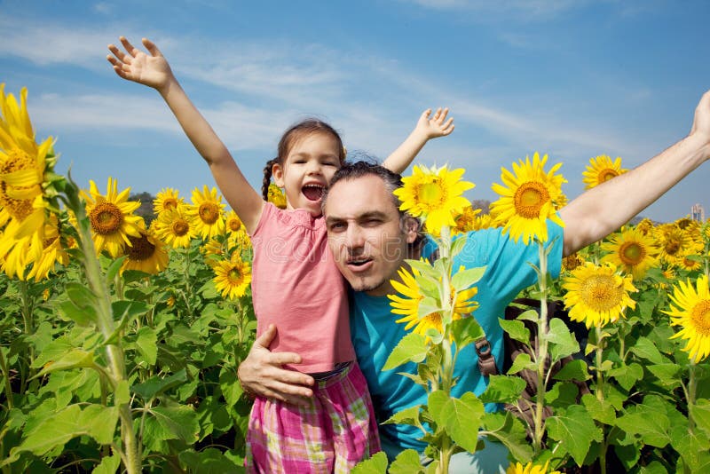 Family on a walk in sunflowers field