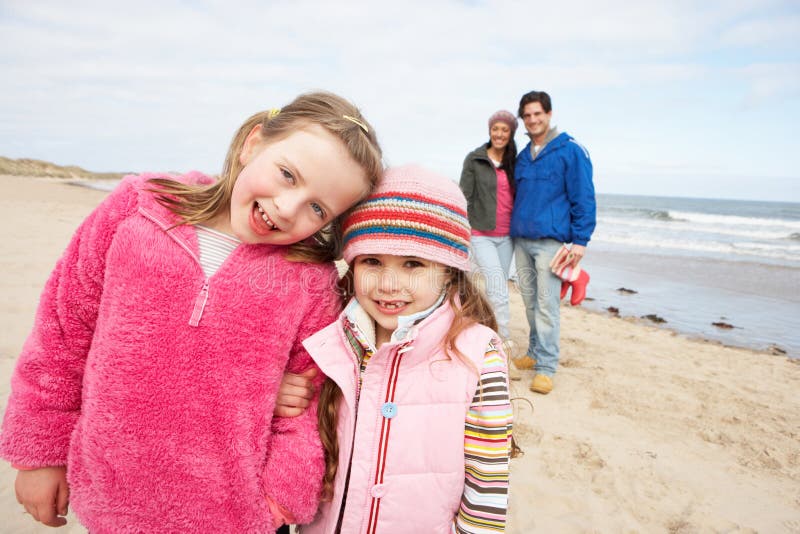 Family Walking Along Winter Beach