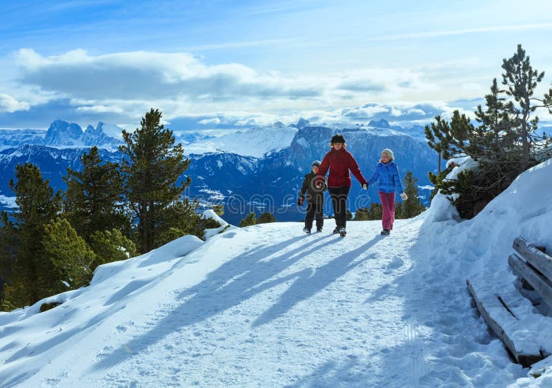Family walking on winter mountain slope stock photos Family walking on winter mountain slope stock photos