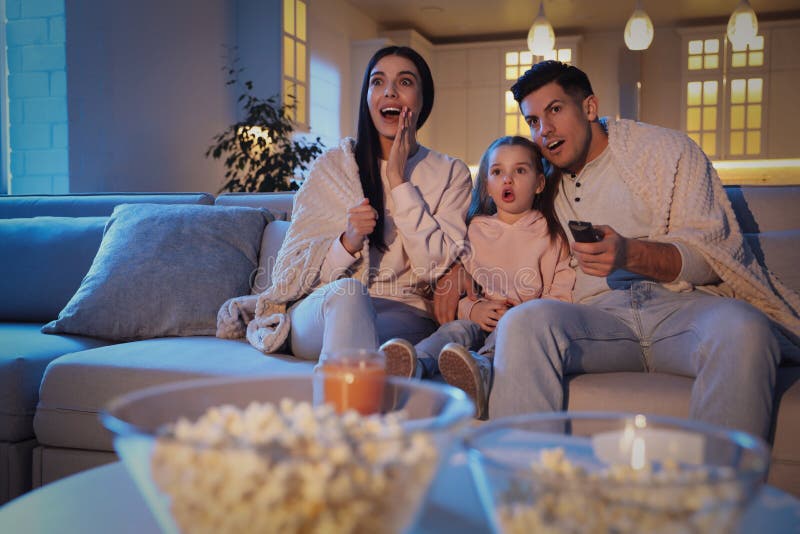 Family Watching Movie on Sofa at Night Stock Photo Image of female