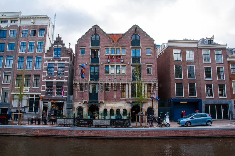 Famous Amsterdam Bulldog coffeeshop and hotel in red-light district during the evening, the Netherlands.