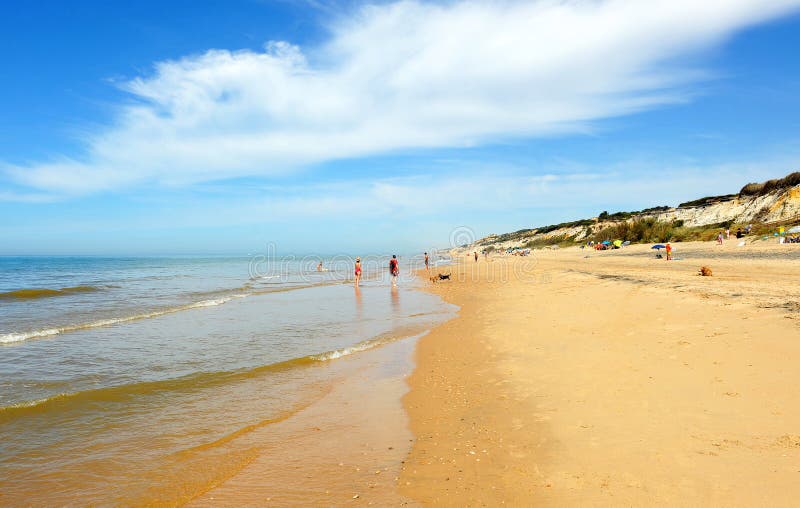 People at Beach of Asperillo and Pico del Loro in Mazagon, province of Huelva, Andalusia, Spain. Famous beach located on the Coast of Light Costa de la Luz, very royalty free stock image People at Beach of Asperillo and Pico del Loro in Mazagon, province of Huelva, Andalusia, Spain. Famous beach located on the Coast of Light Costa de la Luz, very royalty free stock image