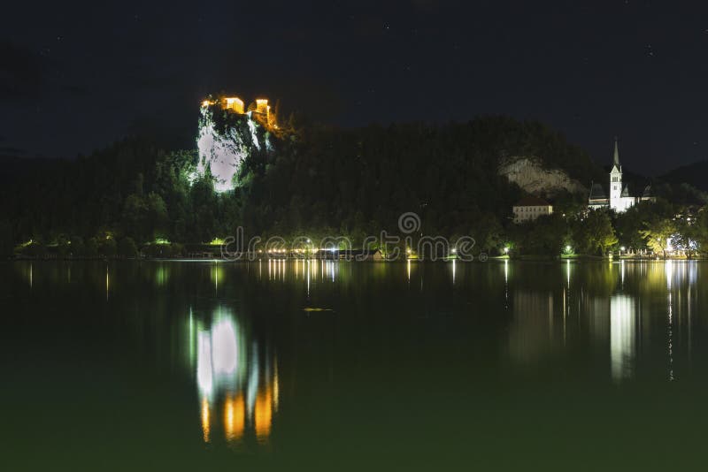 Famous castle and St. Martins Parish Church in the night on Bled lake. Famous castle and St. Martins Parish Church in the night on the Bled lake, Slovenia stock image Famous castle and St. Martins Parish Church in the night on Bled lake. Famous castle and St. Martins Parish Church in the night on the Bled lake, Slovenia stock image