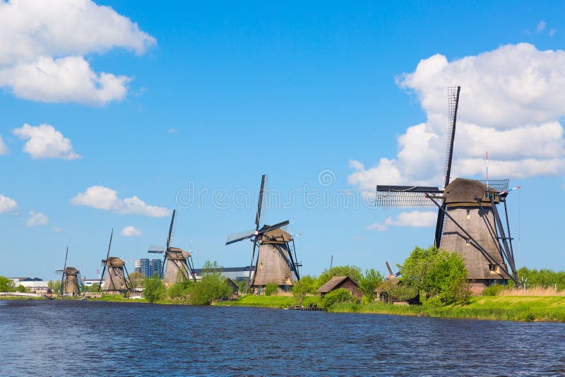 Famous windmills in Kinderdijk village in Holland. Colorful spring landscape in Netherlands, Europe. UNESCO World Heritage and fam