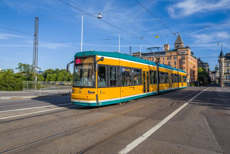 Norrkoping, Sweden – August 4, 2015: Tram crossing Saltangen bridge over Motala river in Norrkoping. The yellow trams are iconic for Norrkoping, which is a historic industrial town. Norrkoping, Sweden – August 4, 2015: Tram crossing Saltangen bridge over Motala river in Norrkoping. The yellow trams are iconic for Norrkoping, which is a historic industrial town.