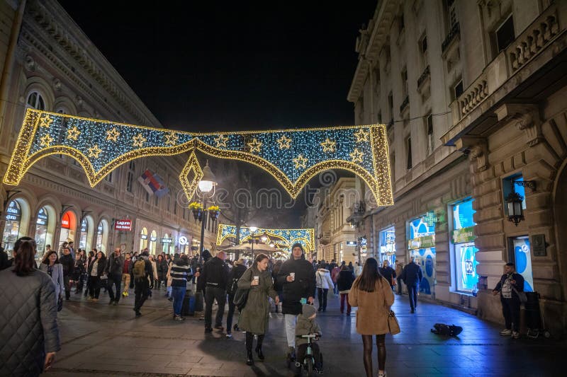 Belgrade, Serbia - December 30, 2023: Picture of the Belgrade Christmas decorations on the Kneza Mihailova (knez mihailo) street at night with a crowd of pedestrians walking, in Belgrade, Serbia. Belgrade, Serbia - December 30, 2023: Picture of the Belgrade Christmas decorations on the Kneza Mihailova (knez mihailo) street at night with a crowd of pedestrians walking, in Belgrade, Serbia