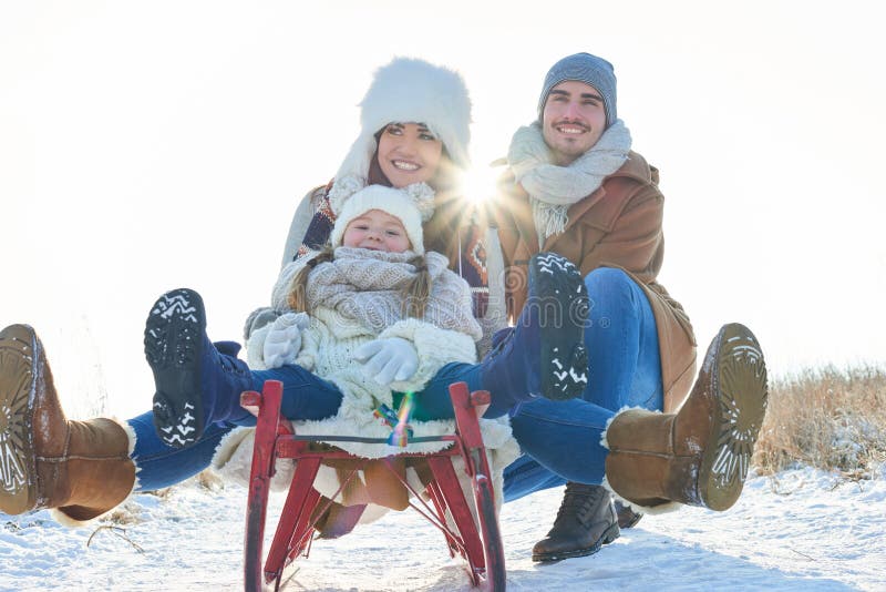 Happy family with sled in winter having fun together. Happy family with sled in winter having fun together