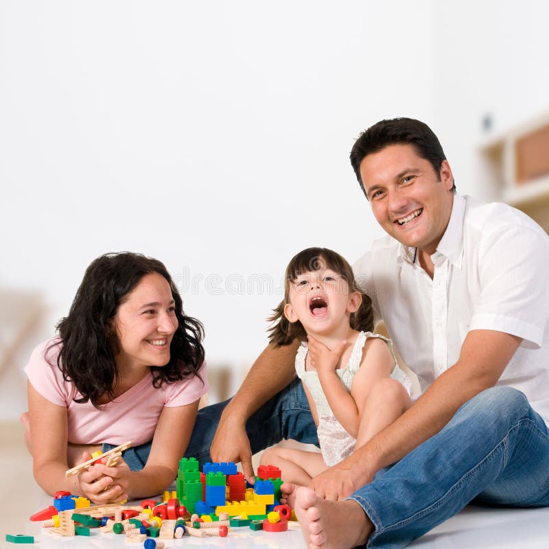Família feliz que joga com blocos