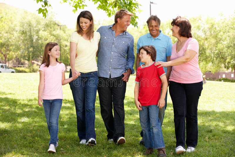 Família latino-americano da geração de Mulit que anda no parque imagens de stock Família latino-americano da geração de Mulit que anda no parque imagens de stock
