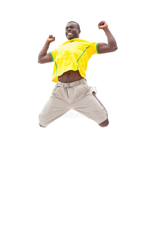 Fan de futebol brasileiro feliz que salta acima fotografia de stock Fan de futebol brasileiro feliz que salta acima fotografia de stock
