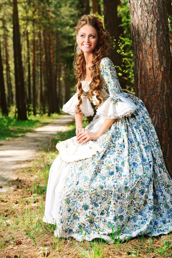 Beautiful young woman in medieval era dress on a sunny day outdoor. Charming elegant european woman stock images, royalty-free photos and pictures