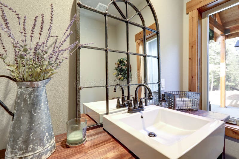 Fantastic bathroom boasts a country style wooden washstand