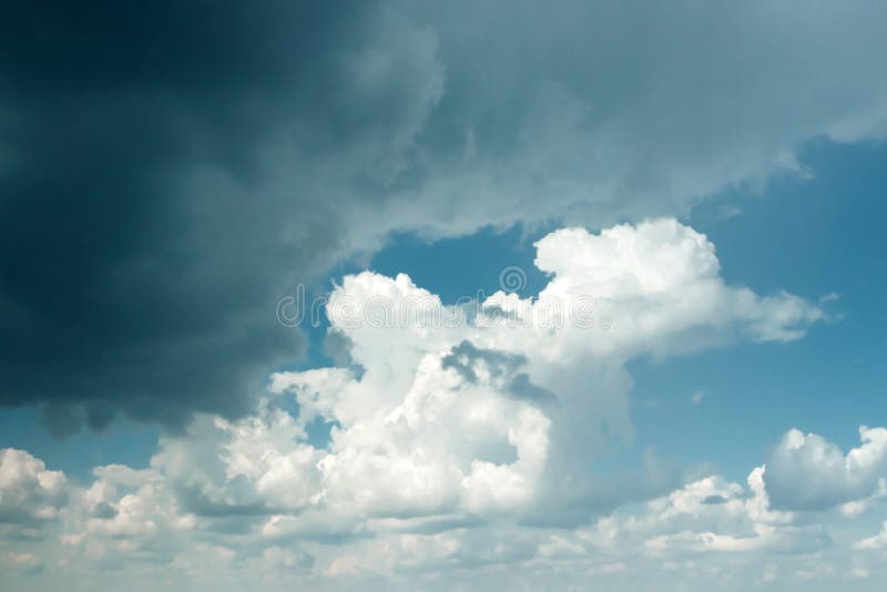Fantastic, fluffy, white clouds against a blue sky. Rain clouds. The situation in the sky before the storm. copy space royalty free stock image Fantastic, fluffy, white clouds against a blue sky. Rain clouds. The situation in the sky before the storm. copy space royalty free stock image