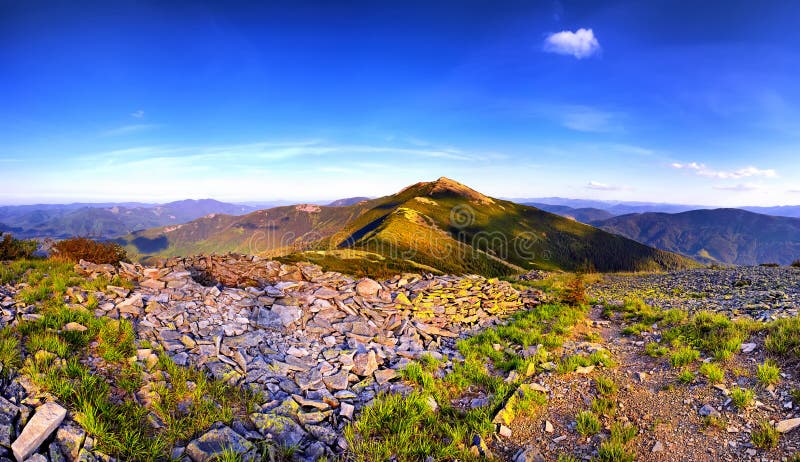 Fantastic panorama sunny hills under morning blue sky. Dramatic stock photos