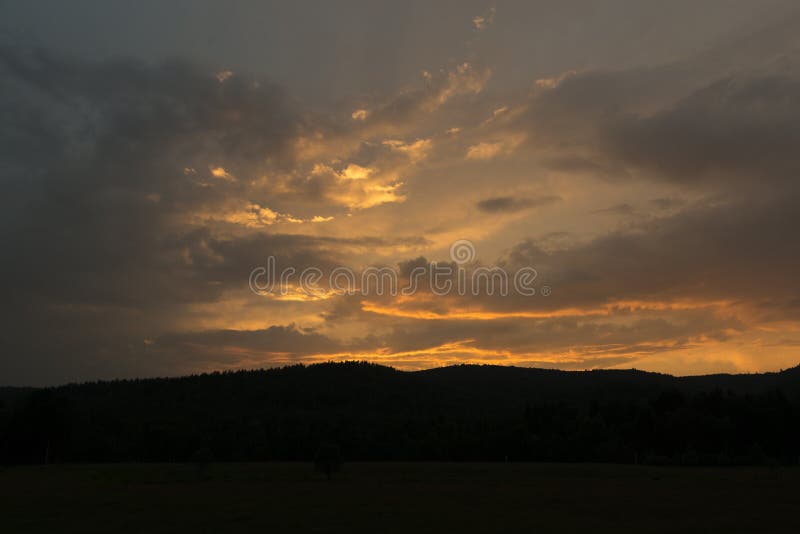 Fantastic red sunset and dark ominous clouds stock photo Fantastic red sunset and dark ominous clouds stock photo