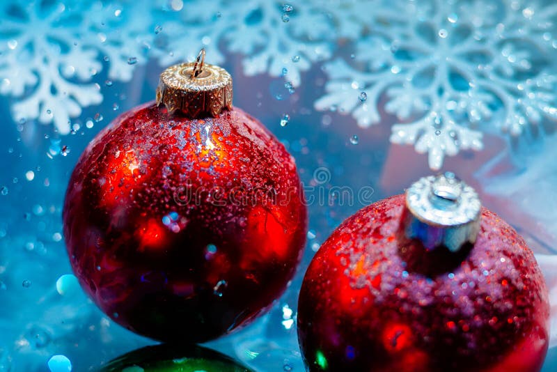 Fancy new year frozen balls with ice water drops bokeh on snowflakes winter background wallpaper. Fancy new year frozen balls with ice water drops bokeh on snowflakes winter background wallpaper