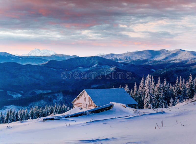 Fantastic sunset over snow-capped mountains and wooden chalets. Fantastic sunset over snow-capped mountains and wooden chalets.