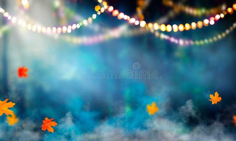 Fantasy Halloween background. Beautiful autumnal forest with garlands and falling leaves