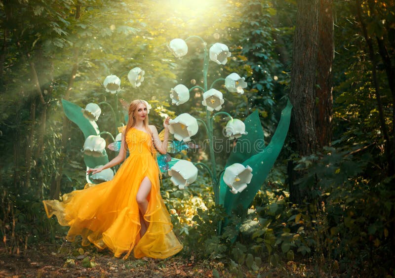 Fantasy woman fairy Girl Fashion model walks in spring summer nature deep forest. Large flower white lily of valley. Green tree rainforest. Divine magic sun
