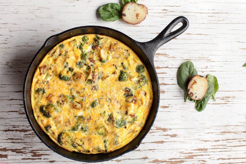 Far away shot of baked egg frittata and spinach