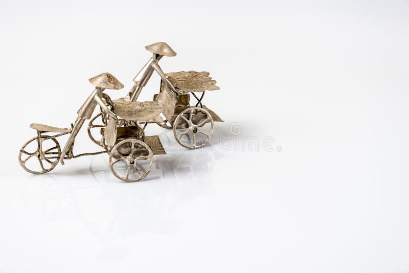 Far eastern three wheel bicycle figurines on white back royalty free stock photos Far eastern three wheel bicycle figurines on white back royalty free stock photos