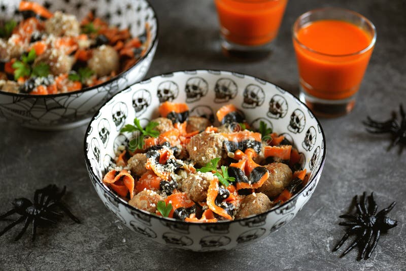 Farfalle Halloween pasta with meat balls and parmesan in a creamy sauce in traditional bowls. Halloween food. stock images Farfalle Halloween pasta with meat balls and parmesan in a creamy sauce in traditional bowls. Halloween food. stock images