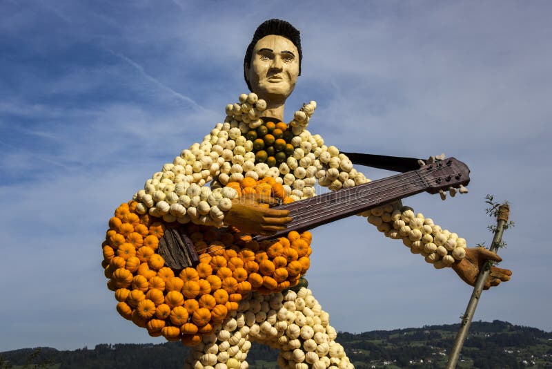 Farm art guitar and guitarist made of small orange, green and white pumpkins