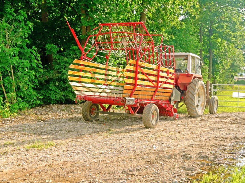 Farm tractor and a trailer stock photo. Image of field 31879960