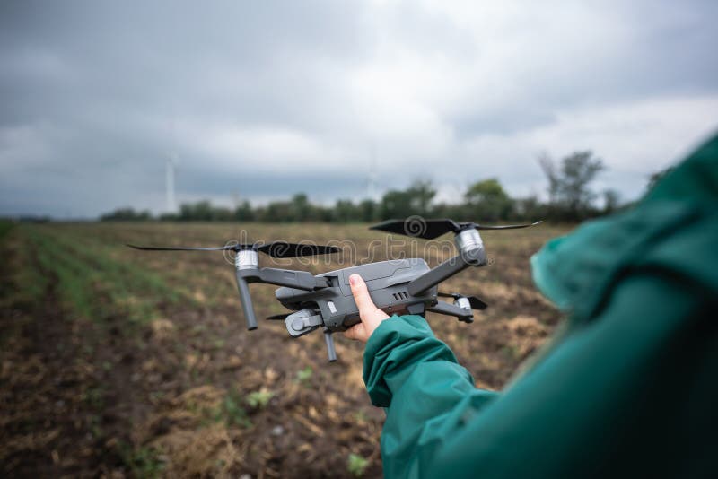 Farmer with drone on a field. Smart farming and precision agriculture. stock images