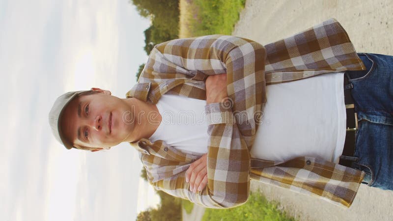 Farmer in front of a sunset agricultural landscape. Man in a countryside field. Country life, food production, farming stock video footage
