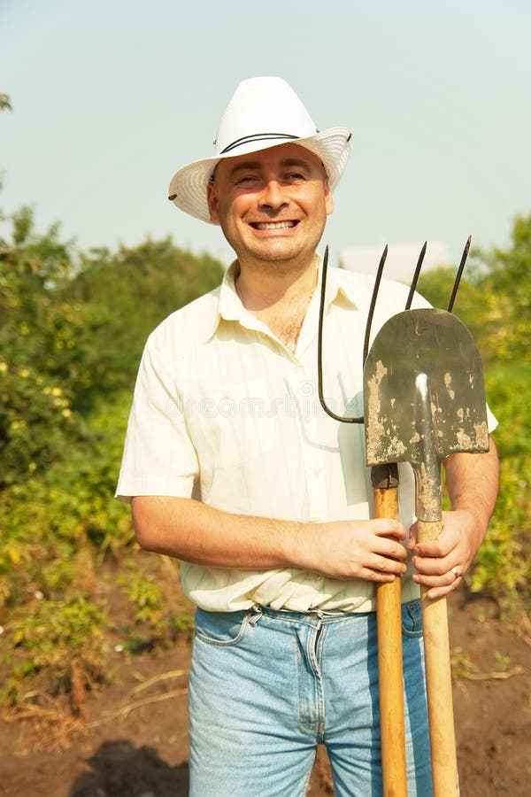 Farmer Holding Pitchfork and Spade Stock Photo Image of male
