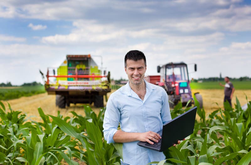 Farmer with laptop during harvest